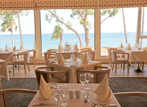 Elegant restaurant at Poseidonia Beach Hotel in Limassol, Cyprus. Travel with World Lifetime Journeys