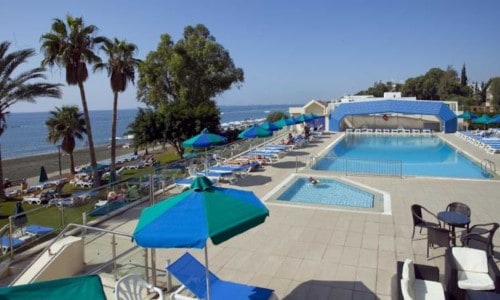 Pool side at Poseidonia Beach Hotel in Limassol, Cyprus. Travel with World Lifetime Journeys