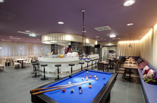 Bar area pool table at Meininger Hotel Downtown Sissi in Vienna, Austria. Travel with World Lifetime Journeys