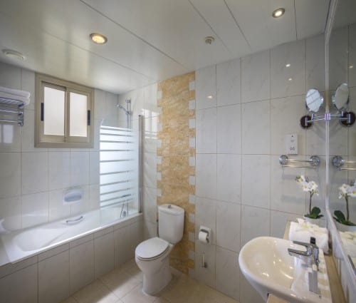 Ensuite bathroom at Aquamare Beach Hotel in Paphos, Cyprus. Travel with World Lifetime Journeys