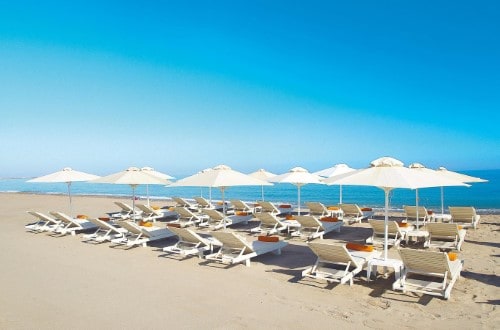 Beach front at Grecotel Plaza Spa Apartments in Rethymno, Crete. Travel with World Lifetime Journeys