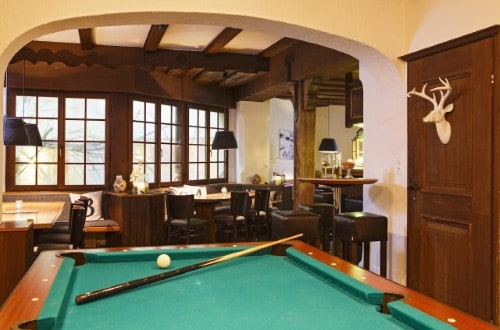 Billiard room at Hotel Sport Klosters, Switzerland. Travel with World Lifetime Journeys