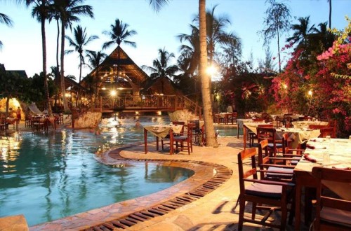 Dining area by the pool at Palumbo Reef, Zanzibar. Travel with World Lifetime Journeys