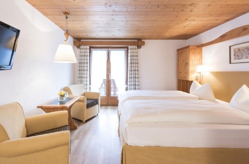 Double room with balcony at Hotel Steinbock in Klosters, Switzerland. Travel with World Lifetime Journeys