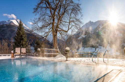 Outdoor pool at Schloss Mittersill Hotel in Kitzbühel, Austria. Travel with World Lifetime Journeys