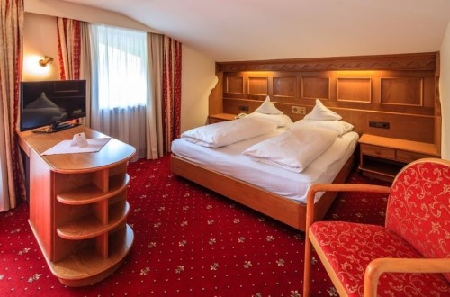 Standard double room at Sporthotel Panorama in Corvara, Italy. Travel with World Lifetime Journeys