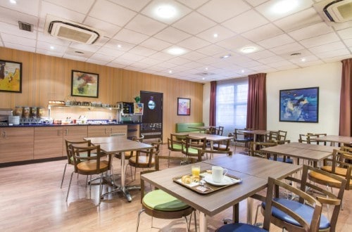 Breakfast room at Canal Suites Hotel La Villette in Paris, France. Travel with World Lifetime Journeys