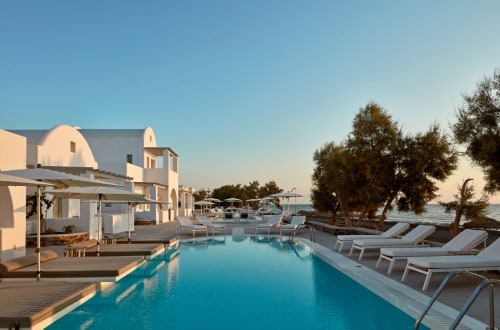 Pool side at Costa Grand Resort & Spa in Santorini, Greece. Travel with World Lifetime Journeys