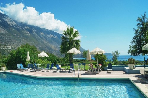 Pool with mountain view at Karavados Beach Hotel in Kefalonia Island, Greece. Travel with World Lifetime Journeys