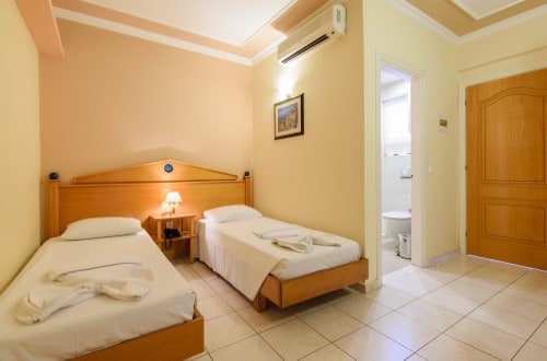 Twin room at Plaza Pallas Hotel in Zakynthos, Greece. Travel with World Lifetime Journeys