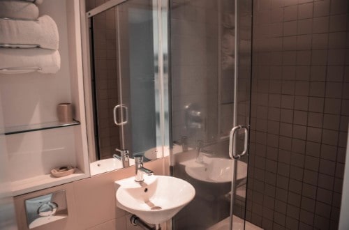 Ensuite bathroom at Hotel 55 in London, United Kingdom. Travel with World Lifetime Journeys